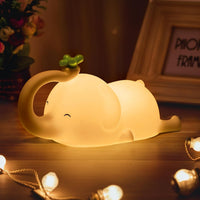 Elephant Night Light glowing on a bedside table